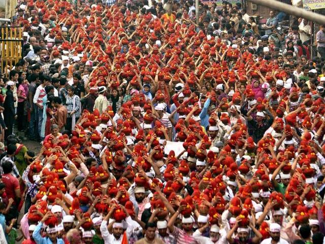 People of Sindhi community carry earthen pots on their heads as they take part in a religious procession on the occassion of Chaliho Sahib Festival in Ahmadabad on Sunday.