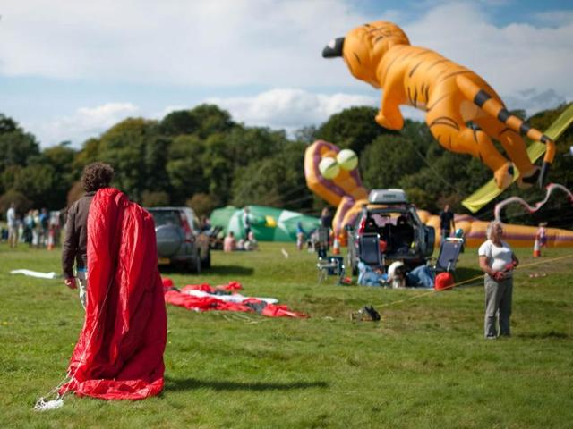 A man carries his kite away from the flying arena at the 25th annual Bristol International Kite Festival on the Ashton Court Estate near Bristol.
