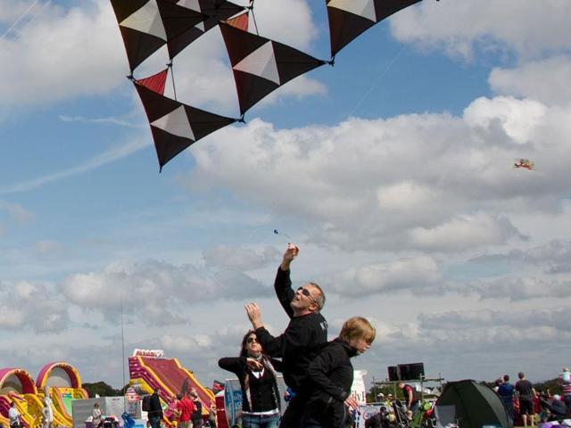 A man launches a kite at the 25th annual Bristol International Kite Festival on the Ashton Court Estate near Bristol.
