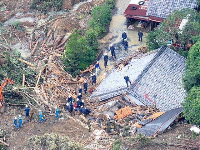 An aerial view of rescue workers searching for missing people among the debris of houses destroyed in Tanabe, Wakayama Prefecture.