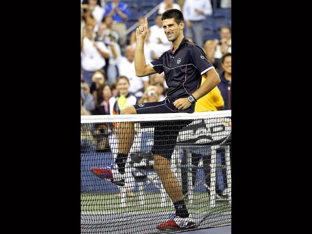 Novak Djokovic, of Serbia, shows off a dance move during an interview at the net after he defeated Nikolay Davydenko, of Russia, in the third round of the US Open tennis tournament in New York.