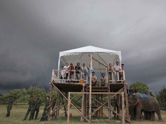 A storm approaches as people watch elephant polo players practicing after the opening parade of the 10th annual King's Cup Elephant Polo Tournament in Hua Hin, nearly 160 km south of Bangkok.