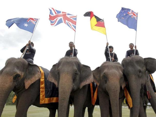 Mahouts hold flags during the opening parade of the 10th annual King's Cup Elephant Polo Tournament in Hua Hin.