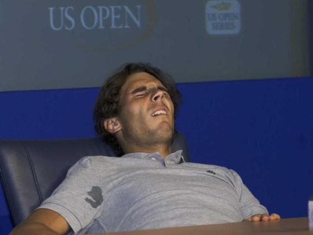 Rafael Nadal of Spain reacts to pain during a press conference after his match against David Nalbandian of Argentina during the US Open tennis tournament in New York.