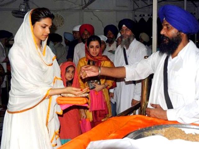 Deepika accepts the prasad from the Lord's house.