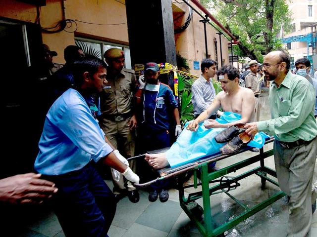 Medical attendants wheel a wounded man to the emergency ward at the RML Hospital.