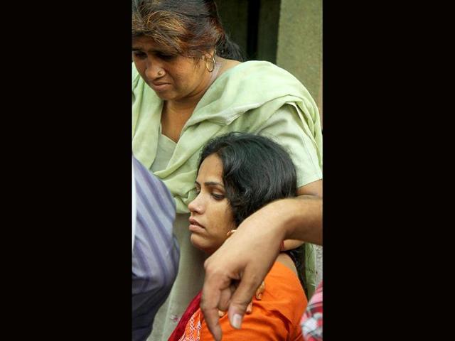 Relatives mourn outside RML Hospital after a powerful bomb blast outside Delhi high court, in New Delhi.