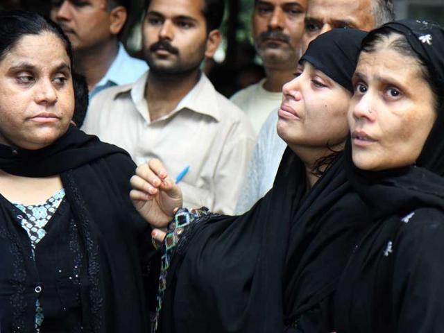 Mourning relatives outside RML Hospital after a powerful bomb blast outside Delhi high court, in New Delhi.