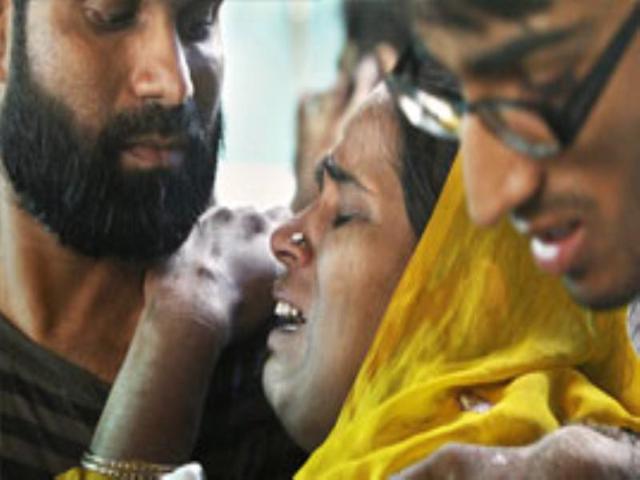 A relative of Delhi high court bomb blast victim wails at the RML hospital.