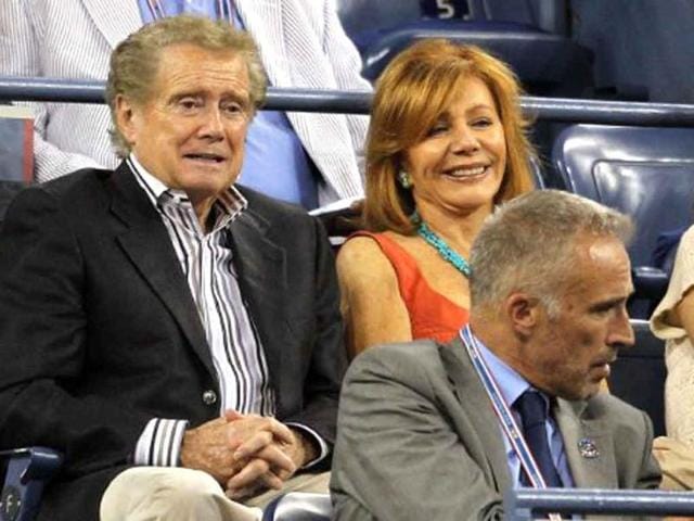 Regis Philbin and his wife Joy watch as Andy Roddick of the United States plays against Michael Russell of the United States during Day Three of the 2011 US Open.