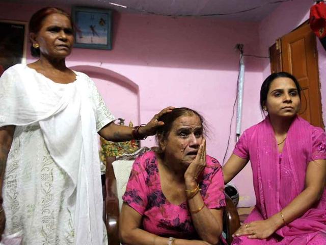 Shyamvati Kaushik weeps for her son Atul, who was injured in Delhi high court blast.