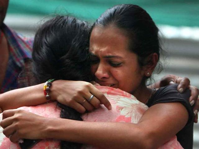 Relatives of a high court blast victim mourn at the RML hospital in New Delhi.