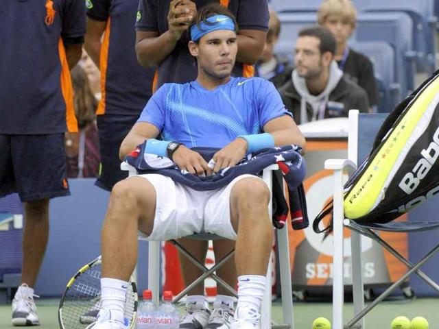 Rafael Nadal from Spain waits in a rain delay against Gilles Muller from Luxembourg during their Men's singles 2011 US Open match at the USTA Billie Jean King National Tennis Center in New York.