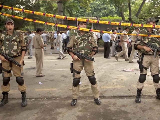 Police secure the scene of a blast outside the High Court in New Delhi. A bomb apparently hidden in a briefcase exploded outside a gate crowded with petitioners waiting to enter the High Court.