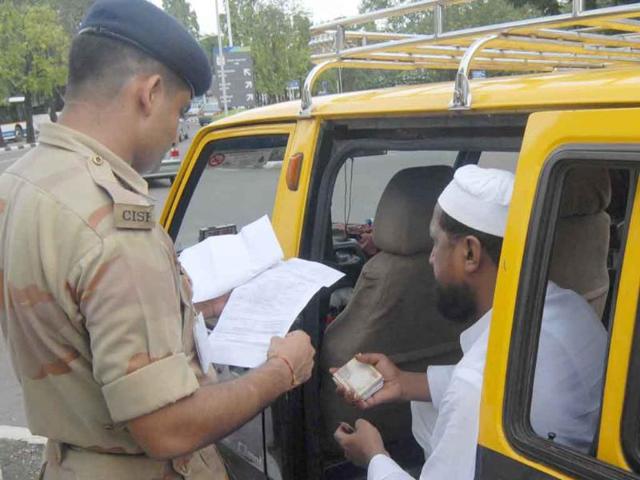 A security personnel checking commuters in Mumbai after a countrywide red alert following the Delhi High court blast.