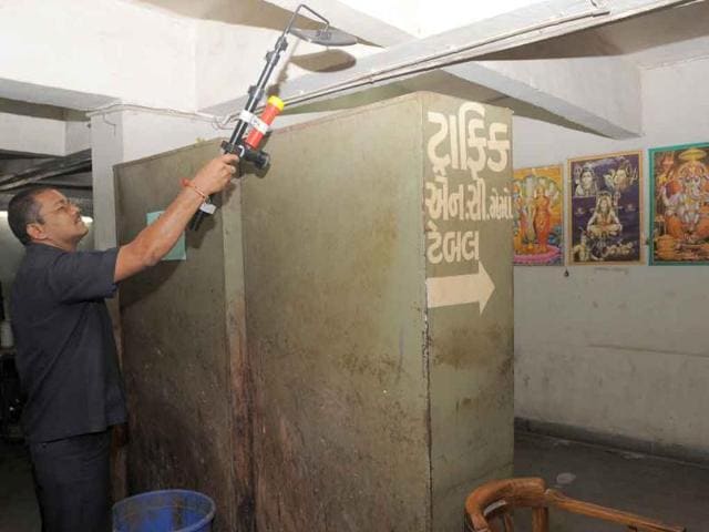 An Ahmedabad Bomb Disposal Squad personnel scans the Traffic Police quarters at the Metropolitan Magistrate's Court Complex in Ahmedabad. Security was increased across the country after a bomb blast ripped through a crowded reception area at the entrance to New Delhi's high court killing 11 and injuring 76.