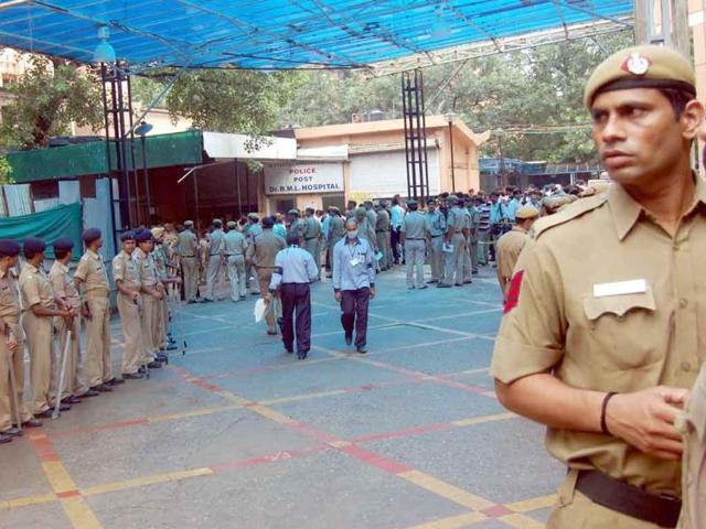 Delhi police personnel maintaining vigil outside the casualty ward of Ram Manohar Lohia Hospital where the injured in the high court bomb blast were admitted, in New Delhi.