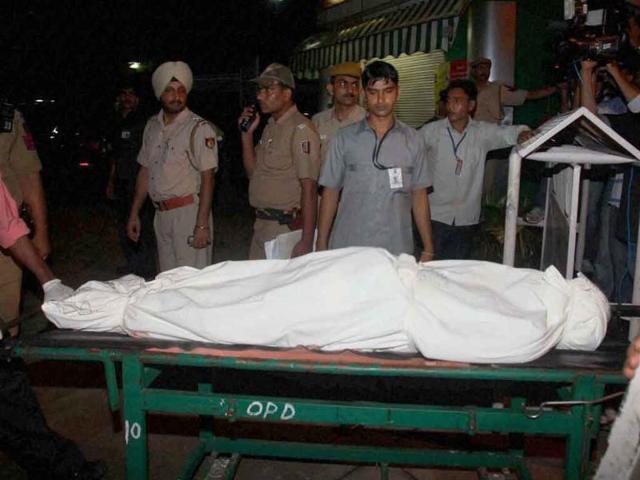 Body of a victim of the high court blast being taken to a mortuary at the RML Hospital in New Delhi.