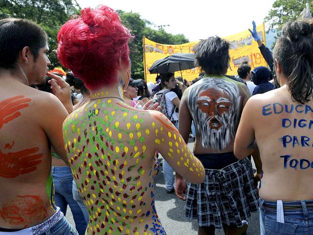 Students with their bodies painted take part in a demonstration in Medellin, Antioquia department, Colombia, as part of a national march in defense of public education.