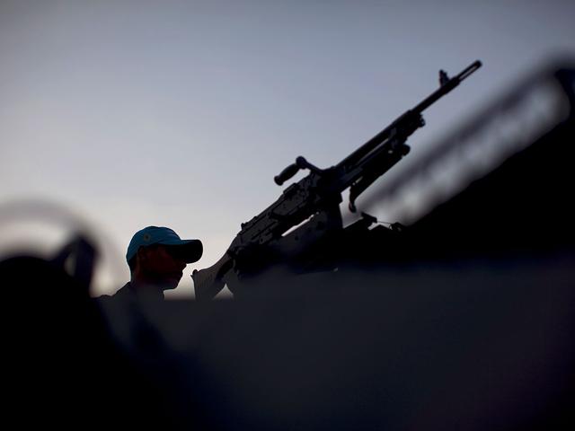 A soldier stand guard at the Alemao slum complex in Rio de Janeiro, Brazil. About 100 marines deployed to help patrol the Alemao slum complex a day after soldiers were fired on by gang members