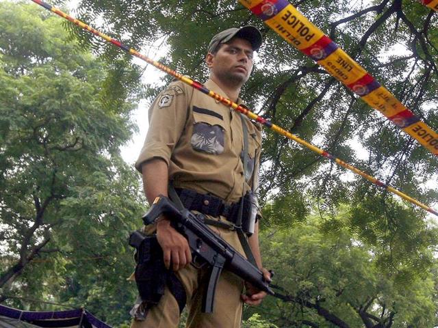 A Special Weapons And Tactics (SWAT) member of the Delhi police force stands guard outsideDelhi high court.