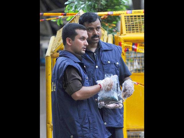National Investigation Agency officers inspect and collect evidence from a deadly bomb blast at the Delhi high court in New Delhi.
