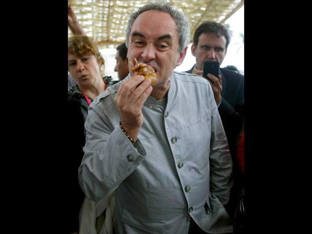 Spanish chef Ferran Adria samples the Peruvian grilled pork dish, 'chancho asado en caja china,' during the IV edition of the Peruvian International Gastronomic Fair 'Mistura' in Lima, Peru.