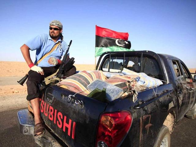 An anti-Gaddafi fighter from the Warfallah tribe prepares to advance to the town of Bani Walid, currently held by pro-Gaddafi forces, in southeast Tripoli.