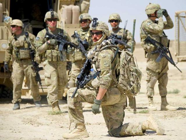US soldiers of the1st Platoon of Task Force 3-66 Bravo Company of the 172. Infantry Brigade stand together during a mission in the village of Babo Khevl in the province of Paktika.