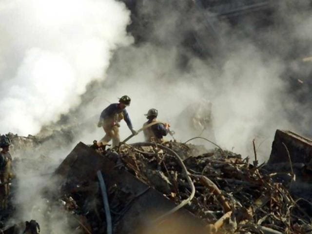 Workers sift through the still-smouldering rubble of the terrorist destroyed World Trade Center 12 October 2001 in New York. File photo.