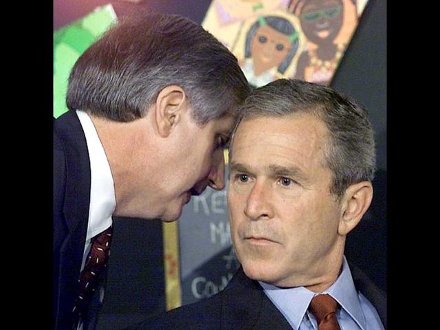 Ex-US President George W Bush being informed by his chief of staff Andrew Card of the attacks on the World Trade Center on September 11, 2001 in New York during an early morning school reading event in Sarasota, Florida. File photo