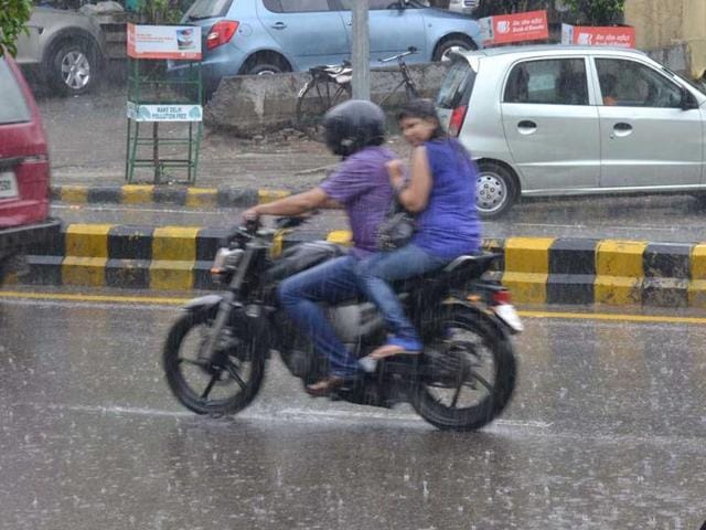 A biker caught in the sudden rain in New Delhi.