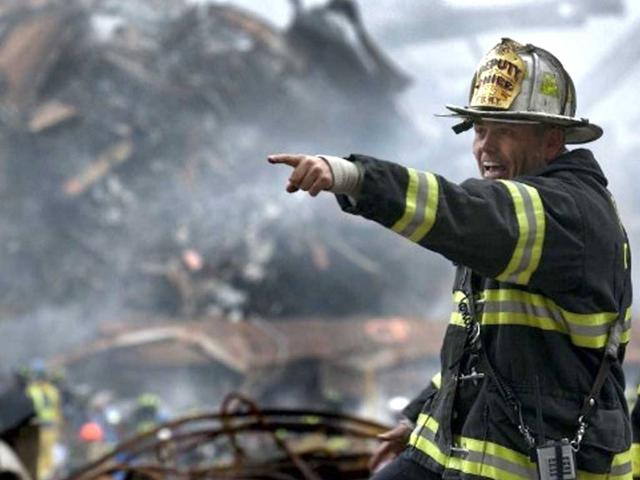This photo released by the US Navy on 18 September 2001 shows Retired Division 13 Department Chief Joseph Curry shouting orders amid the devastation that was once the World Trade Center in New York City 14 September 2001. File photo