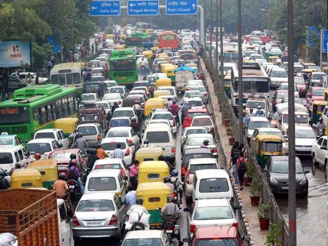 Traffic moves slowly through a flooded road at ITO during heavy rains in New Delhi.