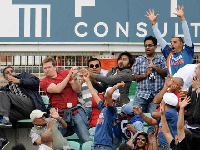 Spectators react as a ball hit by Suresh Raina goes for six during the third one-day international cricket match against England at the Oval cricket ground in London.
