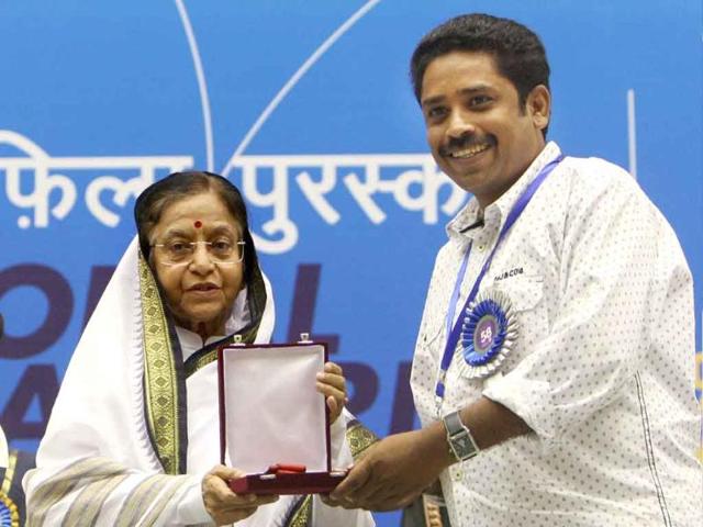 President Pratibha Patil presents Best Tamil Film Award to director Seenu Ramasamy for his film 'Thenmerkku Paruvakkatru' during the 58th National Film Awards Function in New Delhi.