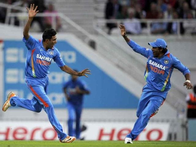 Ravichandran Ashwin celebrates with Ravindra Jadeja after he claims the wicket of England's Jonathan Trott during their one day international cricket match at the Oval cricket ground, London.