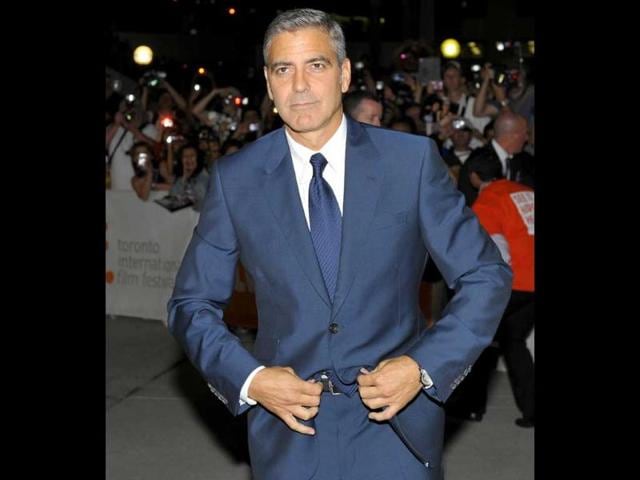 Director and actor George Clooney poses at the gala presentation for his film The Ides Of March at the 36th Toronto International Film Festival.