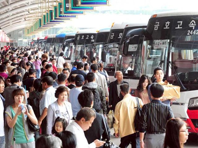 South Korean passengers queue at a bus termial in Seoul as they travel to their home towns and villages across the country to visit relatives during the Korean Chuseok holiday, which lasts from September 11 to 13.