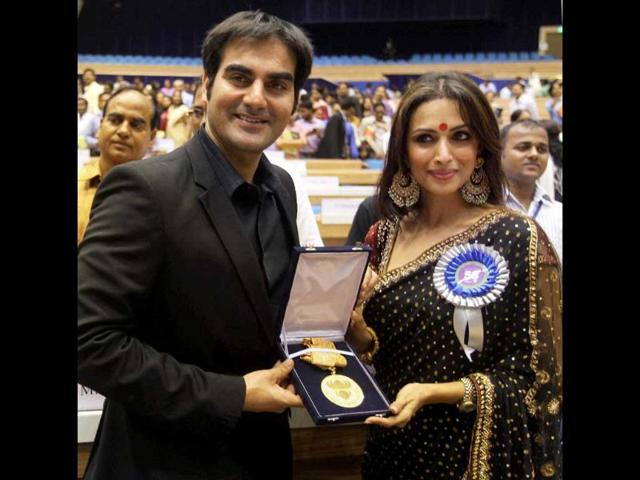 Dabangg producer duo Arbaaz Khan and 'Munni' Malaika Arora flaunt their national award for best popular film providing wholesome entertainment during the 58th National Film Awards function. Check out memorable moments from the event.