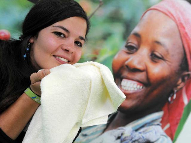 A woman holds a cotton towel produced in Africa in Dortmund, western Germany, during the "Fair 2011" an exhibition for fair trade.
