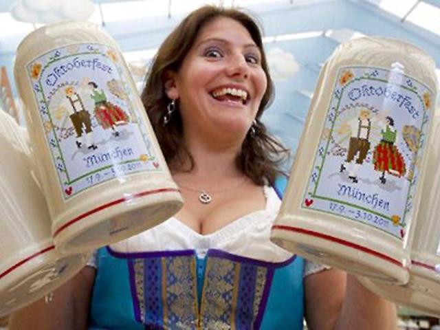 Hostess Melanie presents new beer mugs for the 2011 edition of the world famous Oktoberfest beer festival in Munich.