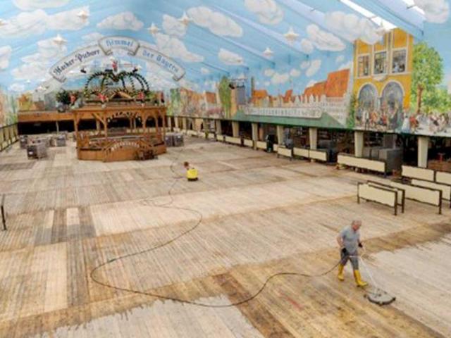 A man works on the floor of a beer tent in preparation of the Oktoberfest beer festival at the Theresienwiese fair ground in Munich.