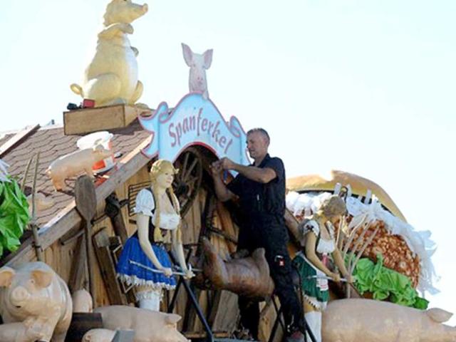 A man works on a booth in preparation of the Oktoberfest beer festival at the Theresienwiese fair ground in Munich.