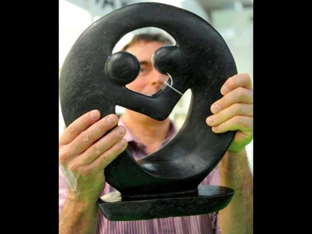 Dutch dealer Daan van Vugt presents stone sculpture from Zimbabwe, in Dortmund, western Germany, during the "Fair 2011" a exibition for fair trade.