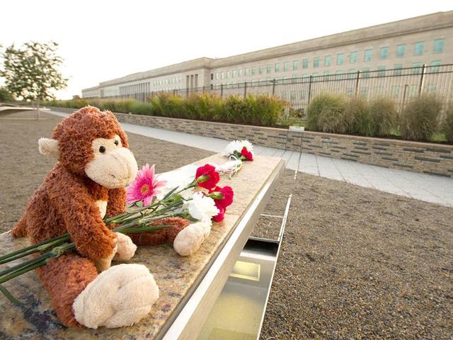 Mementos are left at a 9/11 memorial bench at the Pentagon in Washington, DC.