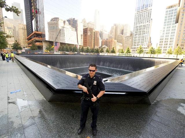 A Port Authority officer stands guard near the south reflecting pool of the World trade Center Memorial in New York.