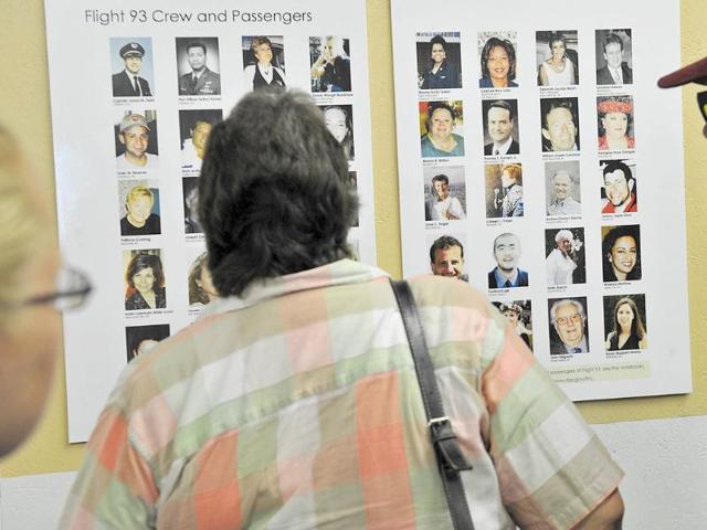 People look at photos of the crew and passengers of United flight 93 at the temporary Flight 93 memorial in Shanksville Pensylvania, on September 9, 2011, near the field where the plane crashed.