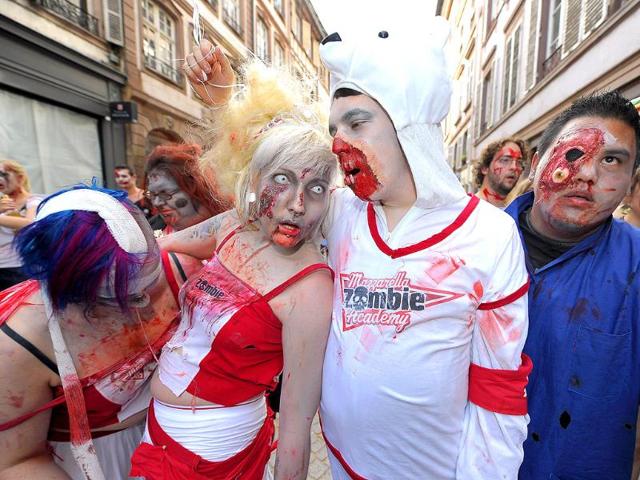 People dressed as zombies take part in the Zombie Walk event.