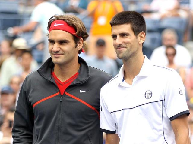 Roger Federer of Switzerland and Novak Djokovic of Serbia pose by the net prior to the start of their match on Day Thirteen of the 2011 US Open at the USTA Billie Jean King National Tennis Center.